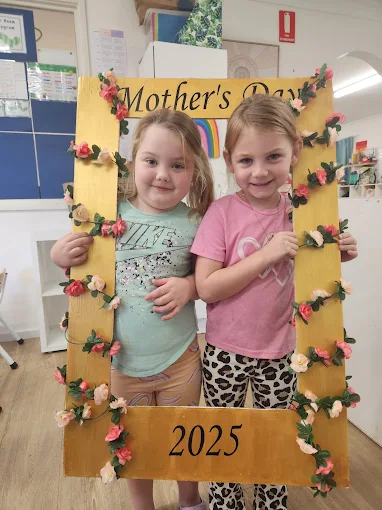lakeside creative minds childcare photo of two toddlers celebrating mothers day with custom photo frame