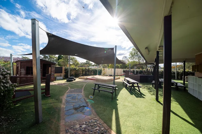 lakeside creative minds exterior childcare facility photo with sandpit sunshade and picnic tables