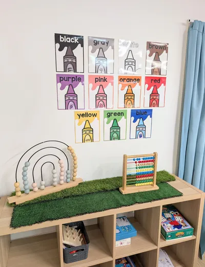 Colour chart, rainbow toy and abacus on a shelf at Lakeside Creative Minds