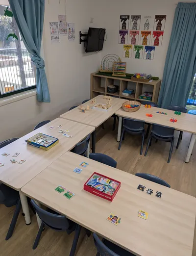 Activity tables set with puzzles and games in a Lakeside Creative Minds room